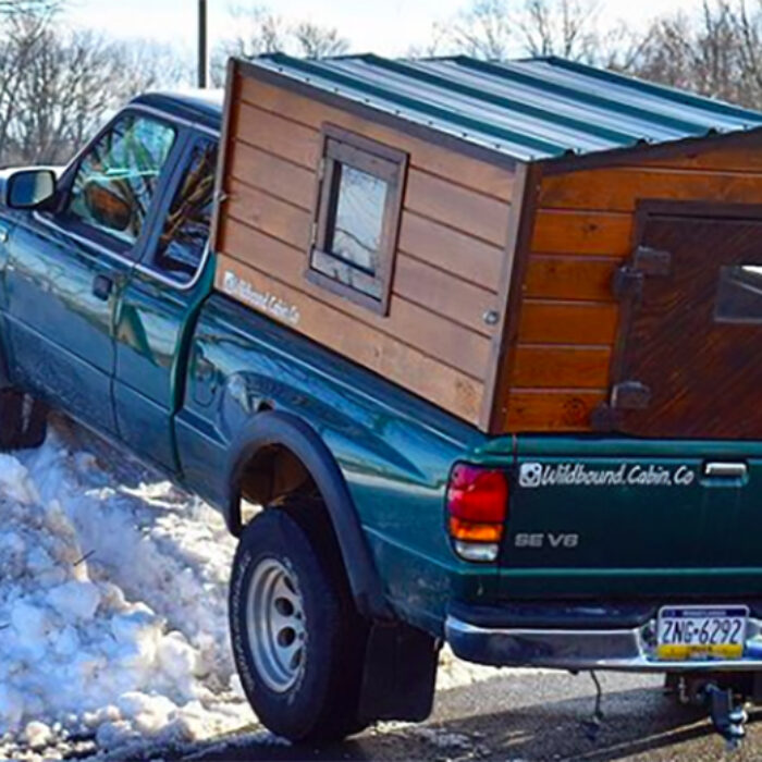 a tiny house cabin camper on a truck