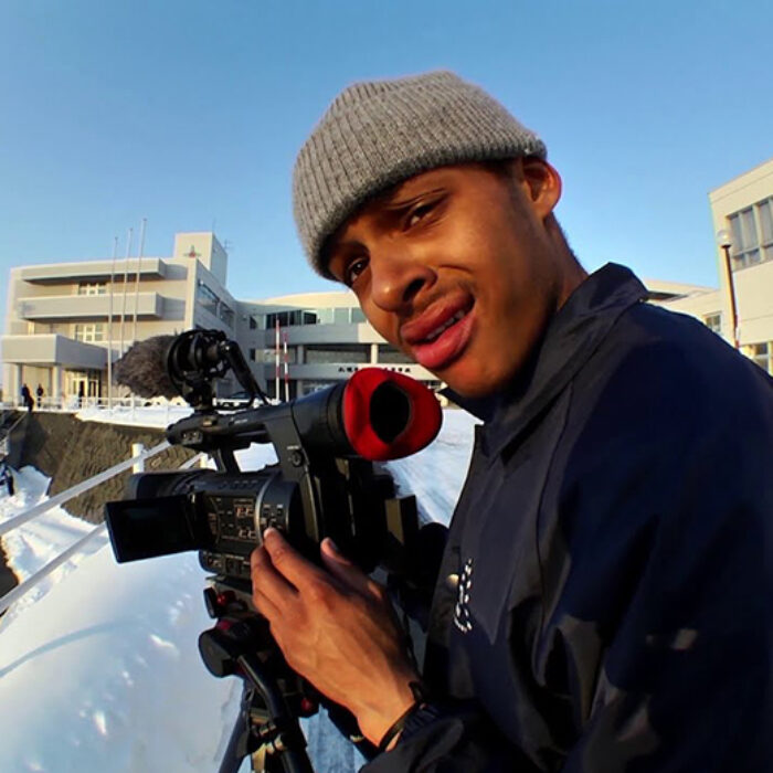 Snowboarder Dillon Ojo looks through the camera