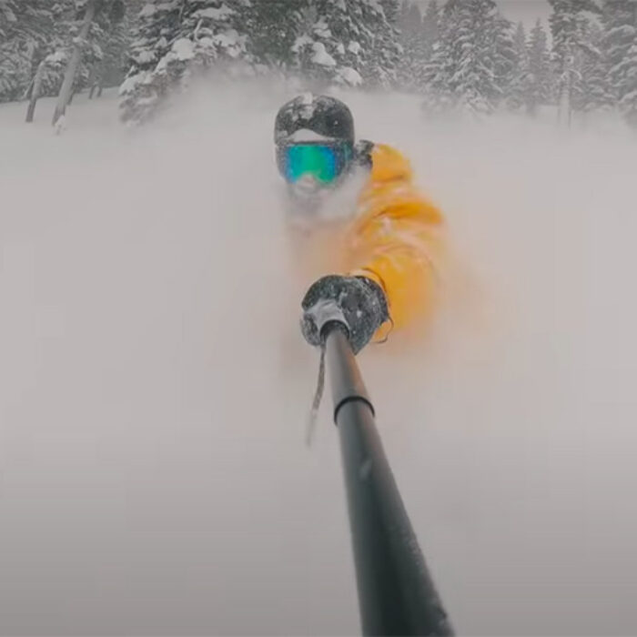 Casey Willax snowboarding in deep powder