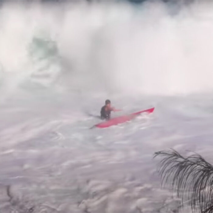 a surfer gets crushed on the paddle out at jaws