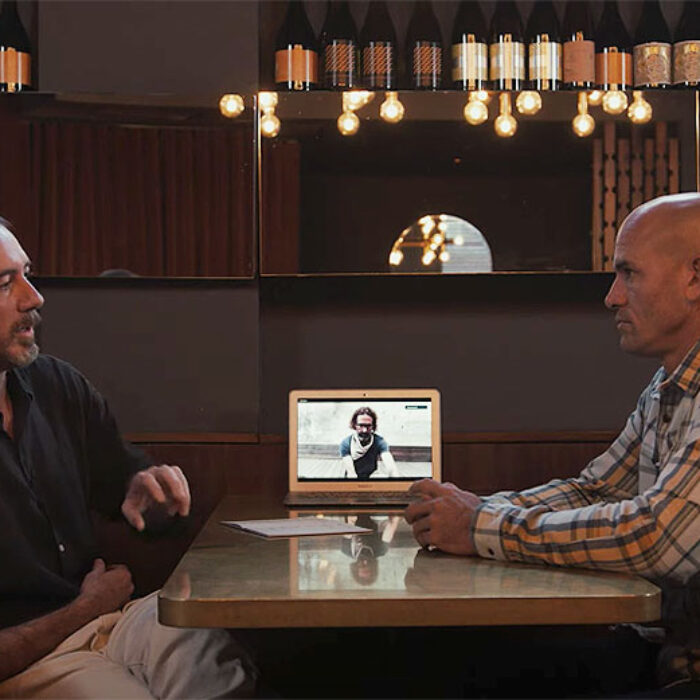 Kelly Slater sitting at a table with John Moore