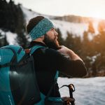 skier on mountain with backpack from unsplash
