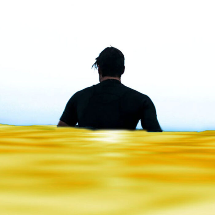 Man sitting in yellow water