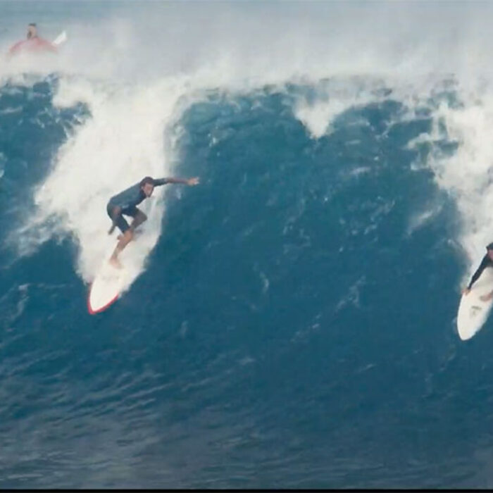Two surfers on wave at Pipeline