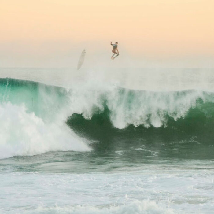 Man falling off back of wave