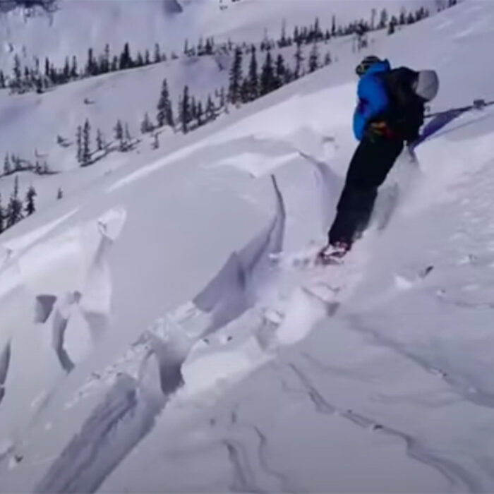 A skier is nearly caught in an avalanche.