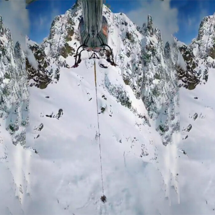 A helicopter bombs slopes to control avalanches in Chamonix