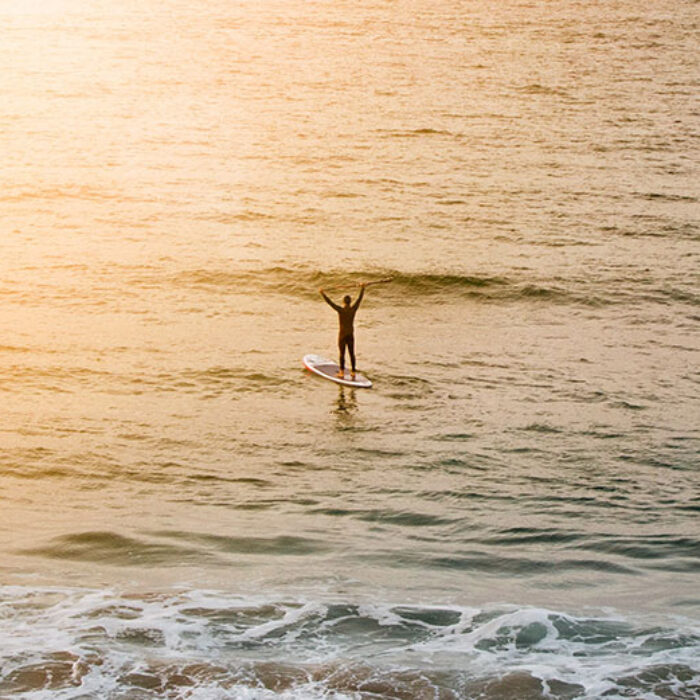 Paddler celebrating on ocean