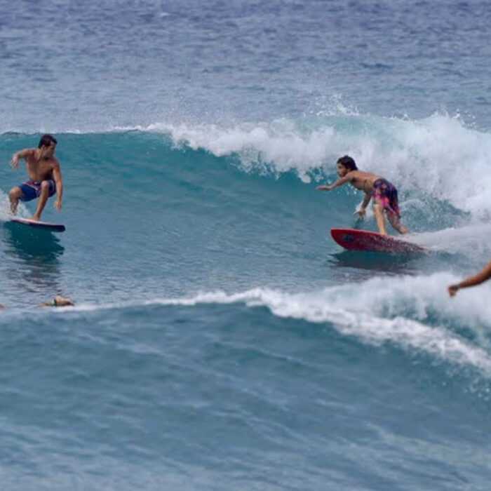 Mason Ho and Sheldon Paishon surfing the same wave at Makaha