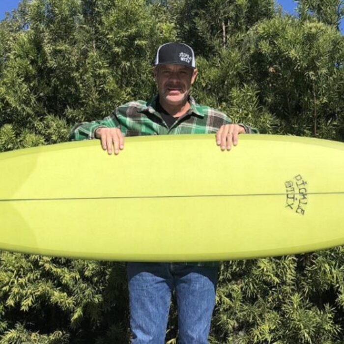 erik smelly sandin with a pickestix surfboard