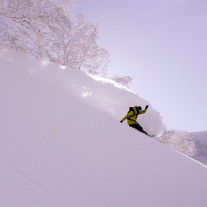 Alex Yoder makes a big turn on a snowboard in Japan