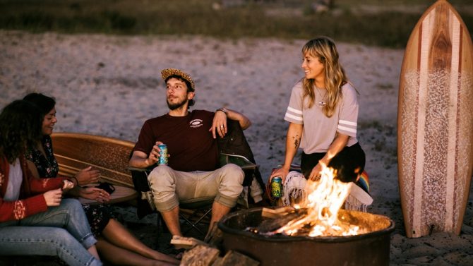 ryan lynch and friends around a bonfire, timber surf co
