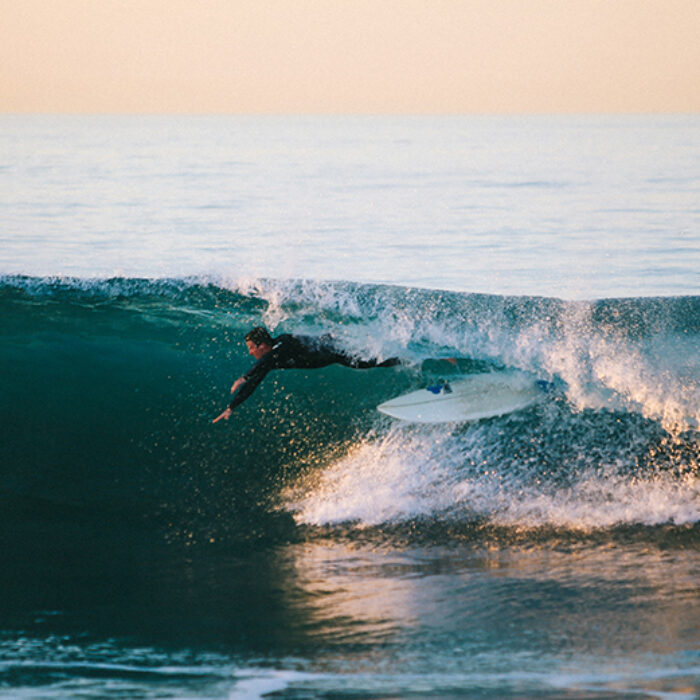 a surfer wipes out in the barrel