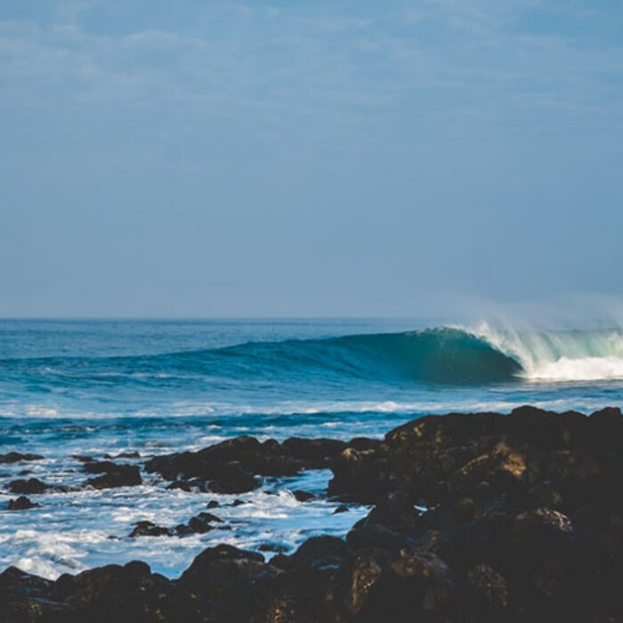 empty wave breaking on rocks