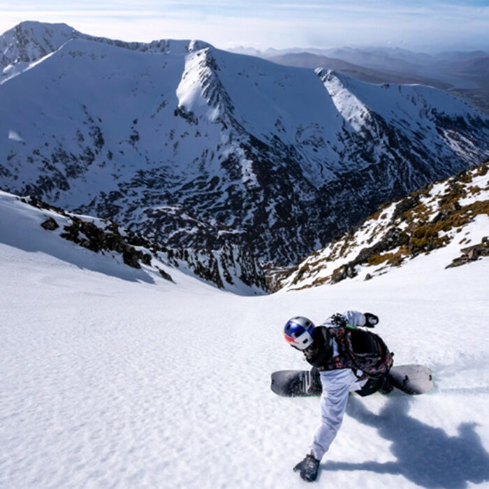 A snowboarder rips a line in the Scottish Highlands