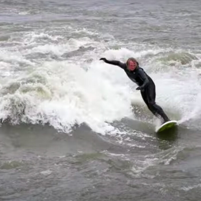 Ben Gravy surfs a river wave in Vermont