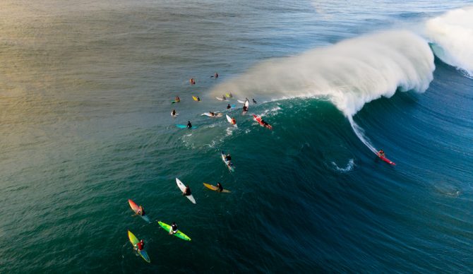 surfers at waimea bay, HI