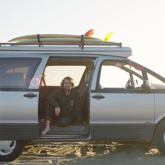 Jay Nelson sits in his pop-top camper