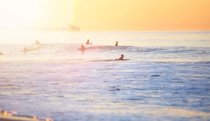 surfers at sunset