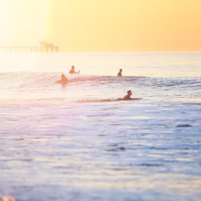 surfers at sunset