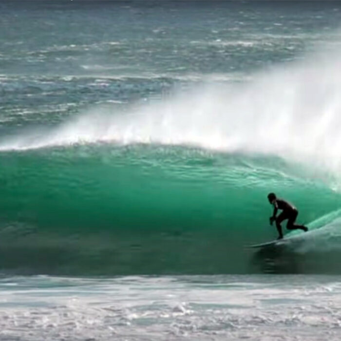 A surfer rides a barrel on Vancouver Island