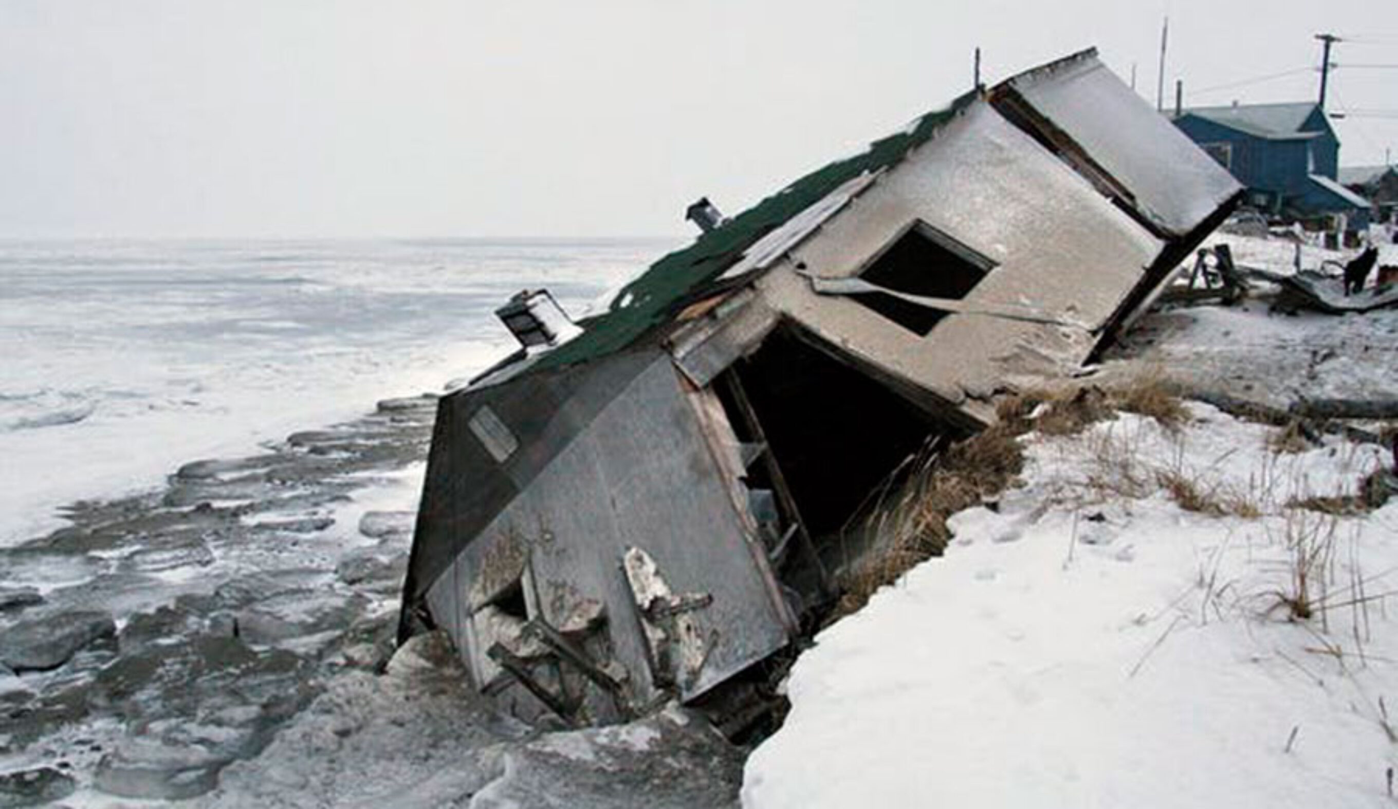 An abandoned house sits on a beach after a storm in Shishmaref, Alaska