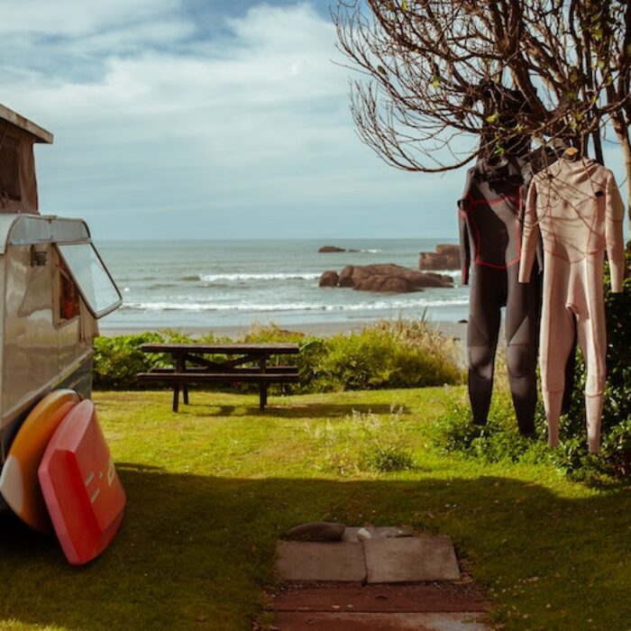 wetsuits hanging at a campsite