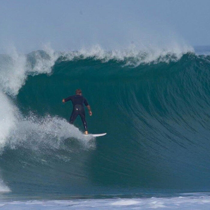 A surfer pulls into a barrel in San Diego