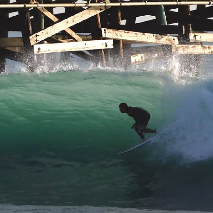 Mason Ho surfing the San Clemente Pier