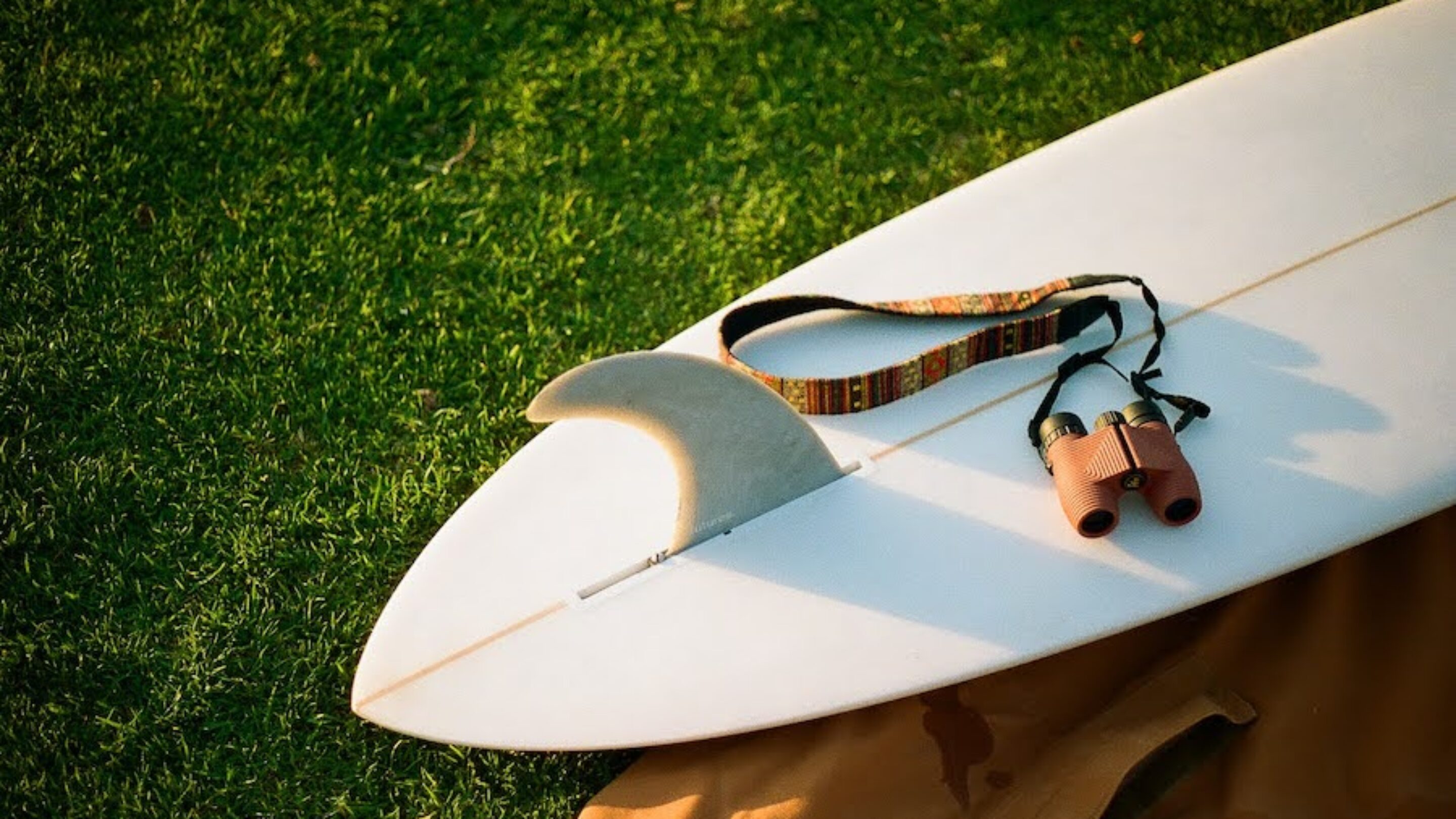 Nocs binoculars on a surfboard