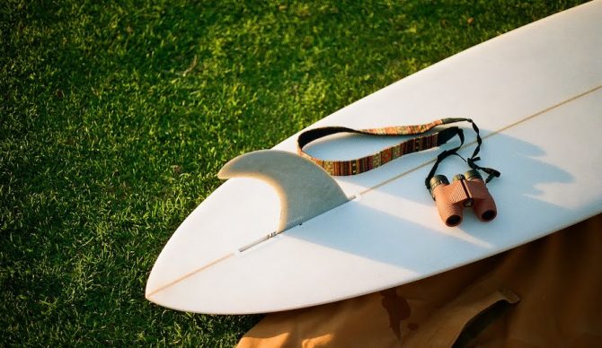 Nocs binoculars on a surfboard