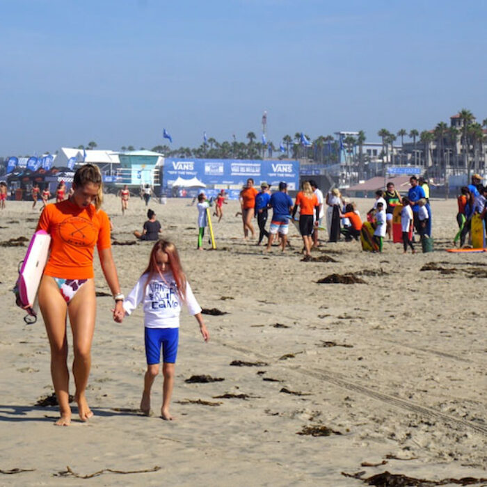 Pua walks a camper down the beach