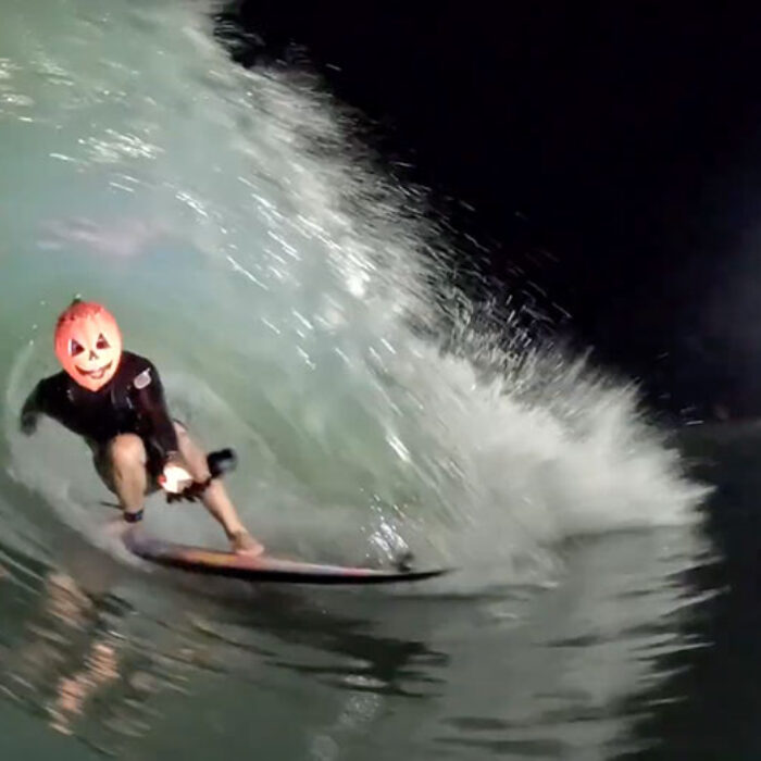 Mason Ho surfing in a pumpkin head mask