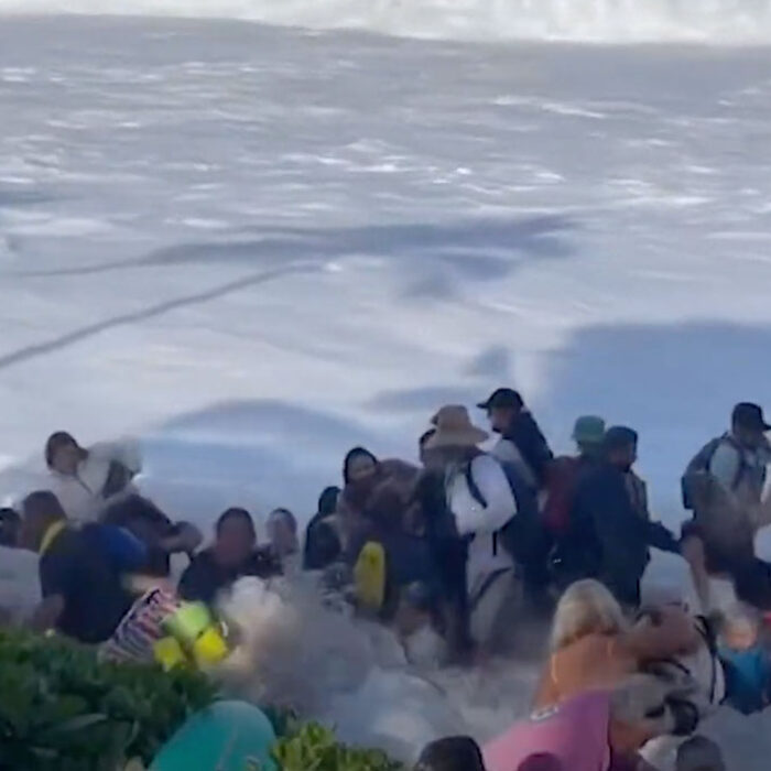 The Eddie big waves wash into crowd