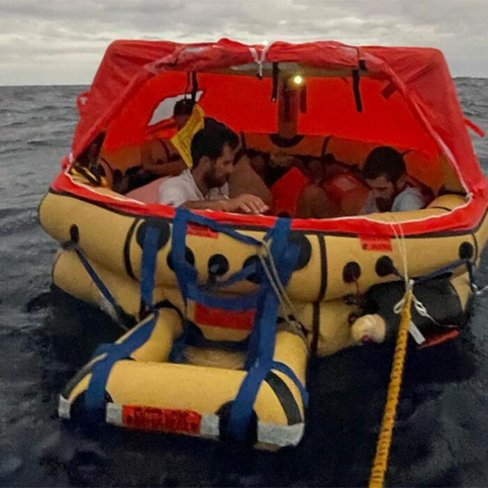 sailors in life raft after whale strike
