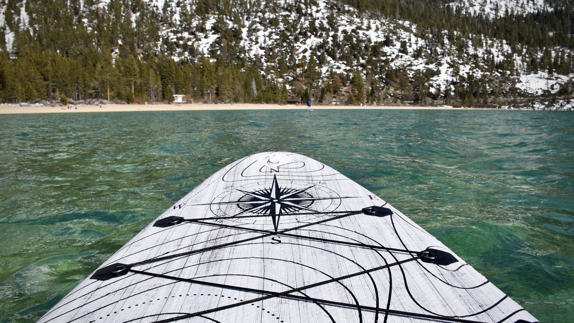 nose of the funwater discovery 11 inflatable paddle board looking towards the shore and mountains of lake tahoe