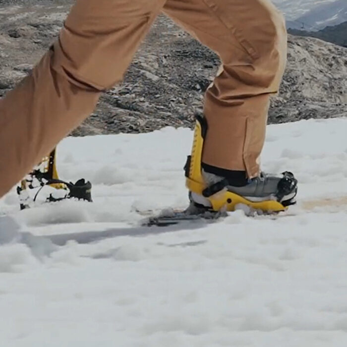 a snowboarder pushes along like a skateboarder