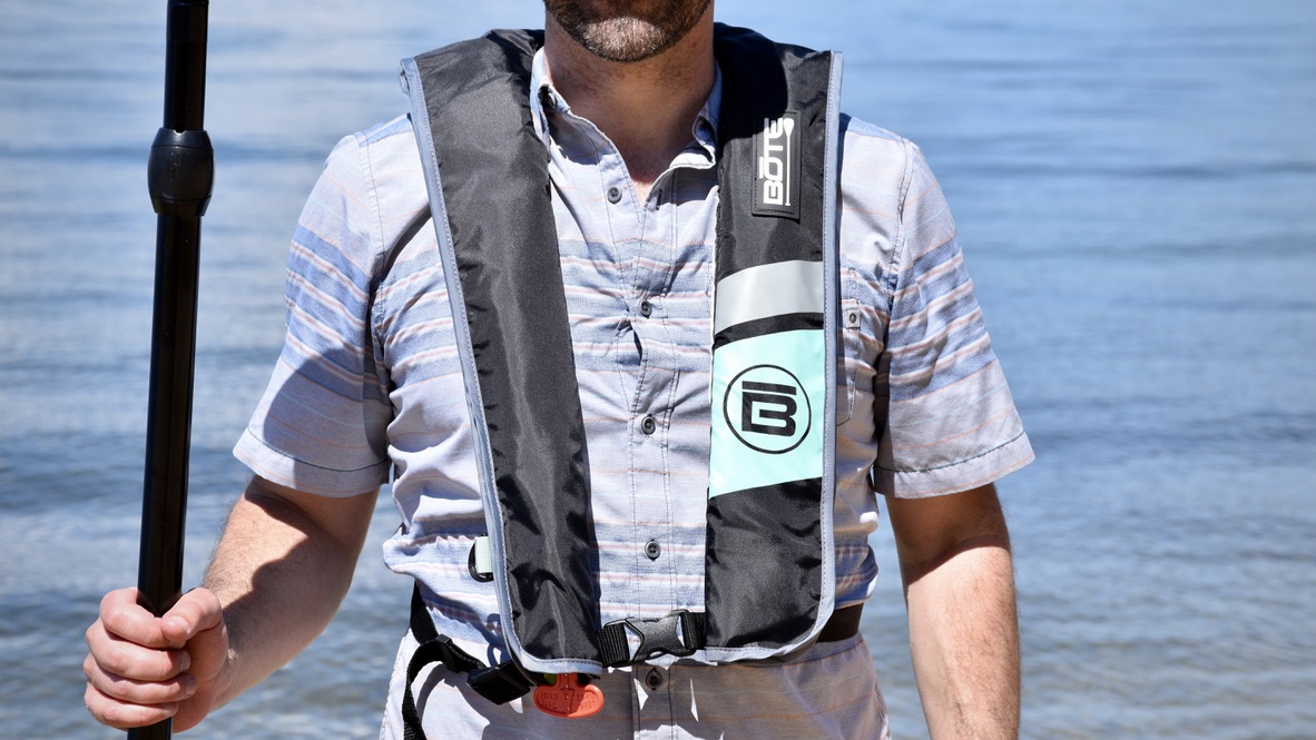 man wearing the Bote inflatable vest life jacket with Lake Tahoe in the background