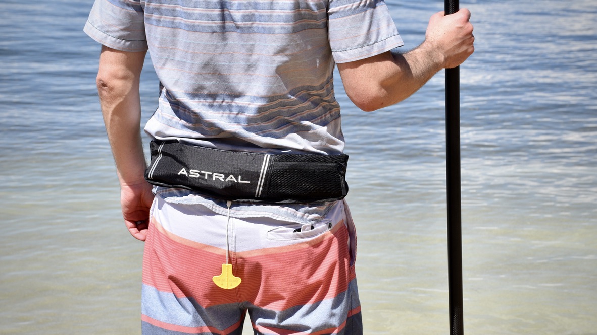 man wearing the astral airbelt inflatable life jacket near lake tahoe