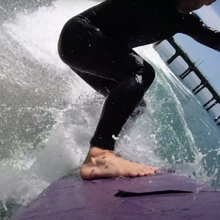 Travis Logie rides a sandpaper surfboard.