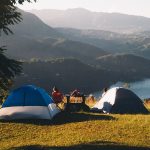 a campsite overlooking a mountain view and lake. photo by Victor Larracuente on Unsplash