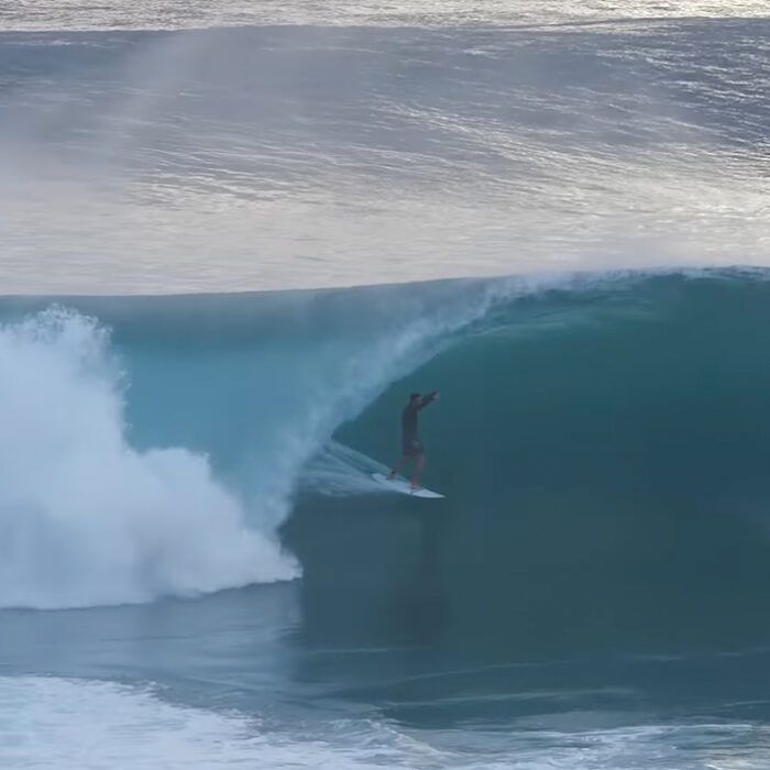 A surfer getting barreled at Growers in Desert Point.