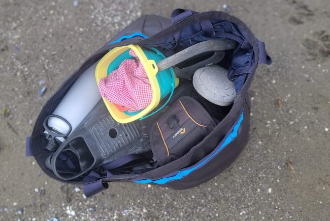 a photo of beach contents in the cotopaxi allpa gear hauler 60L tote