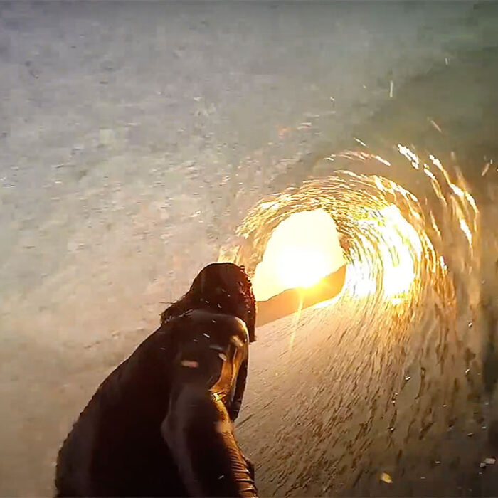 Mikala Jones surfing