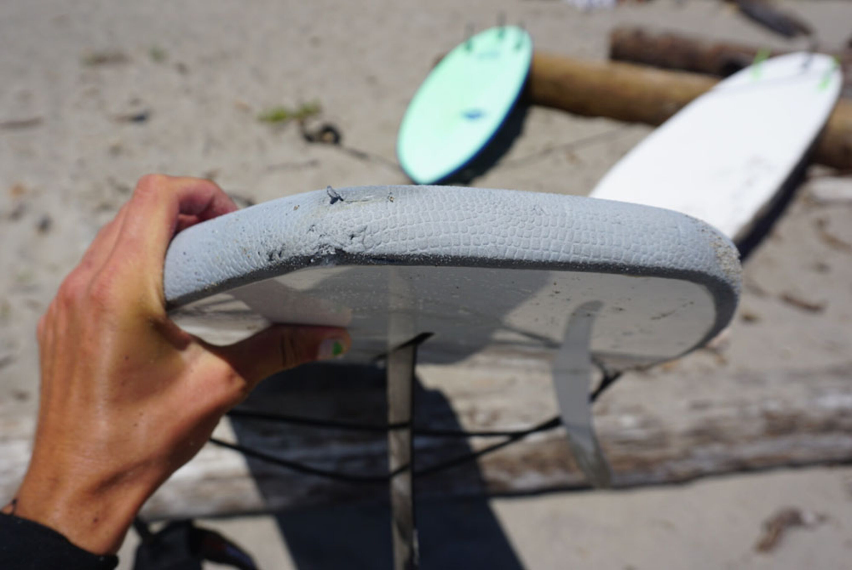 a close up view of the Isle Coronado and the dings that don't ruin performance, for our test of the best soft top surfboards.