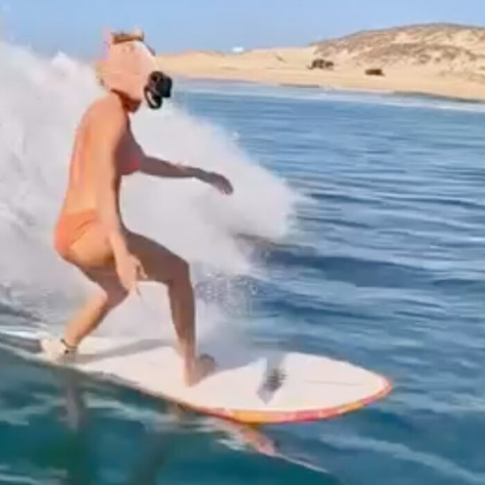 Ivy Miller surfs in a horse head mask.