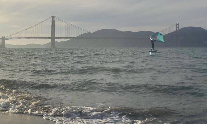 Light wind wing foiling with the golden gate bridge