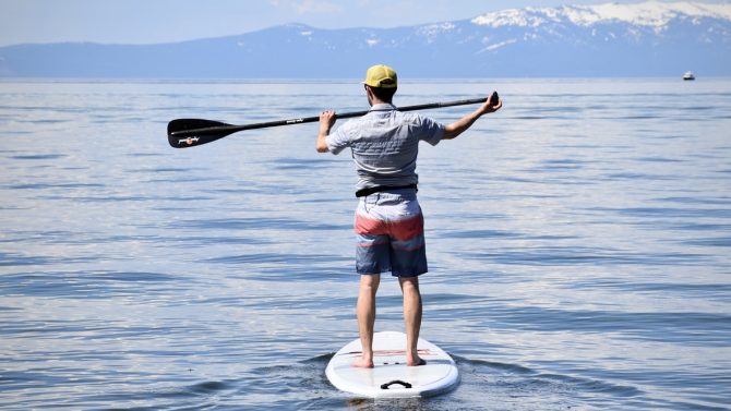 man paddle boarding on lake tahoe