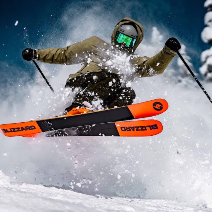A skier hits some powder.
