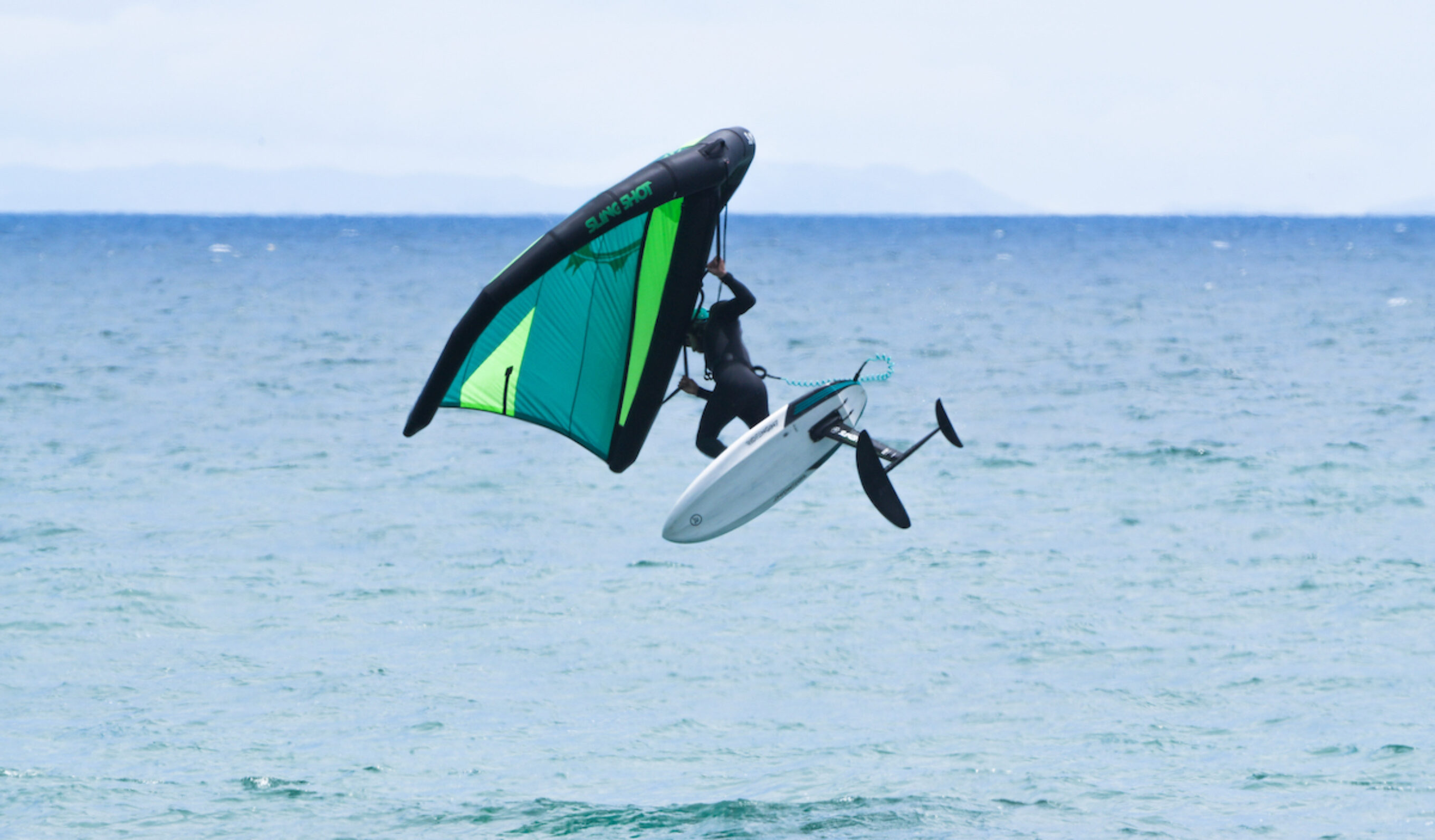 Jesse Faen jumping while wing foiling